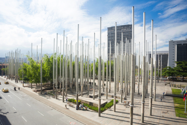 Parque Las Luces in Medellín Centro — tall illuminated steel columns public art installation backdrop
